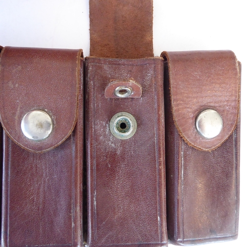 209 - Three leather pistol holsters and three leather magazine holders:
 a Bianchi 'Phantom' shoulder hols... 