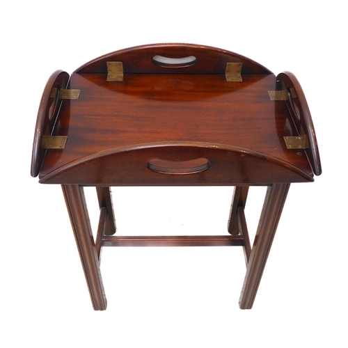 313 - A small oval folding mahogany butler's tray on stand (as a table) with brass hinges and folding side... 