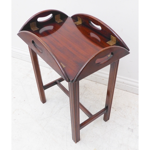 313 - A small oval folding mahogany butler's tray on stand (as a table) with brass hinges and folding side... 