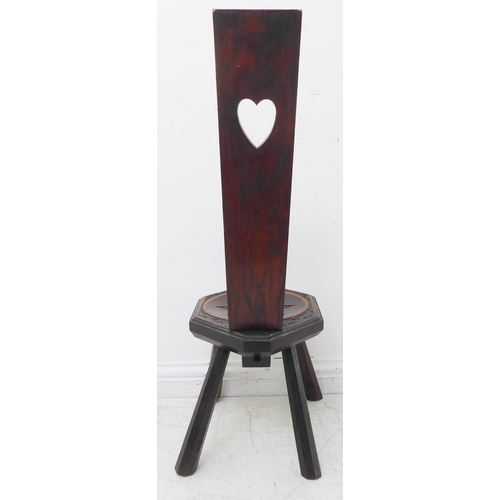 338 - An early 20th century carved oak Welsh spinning stool, the vertical upright with a heart motif (90cm... 