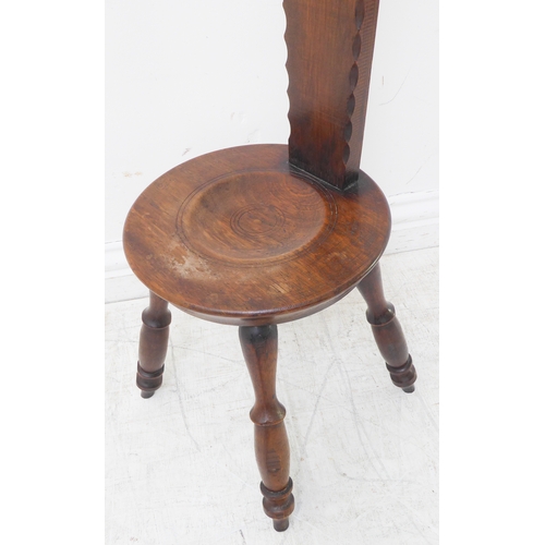 338 - An early 20th century carved oak Welsh spinning stool, the vertical upright with a heart motif (90cm... 