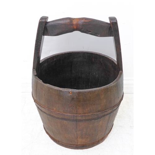 366 - An early 20th century coopered Chinese pail with shaped handle (39cm diameter x 50cm high)