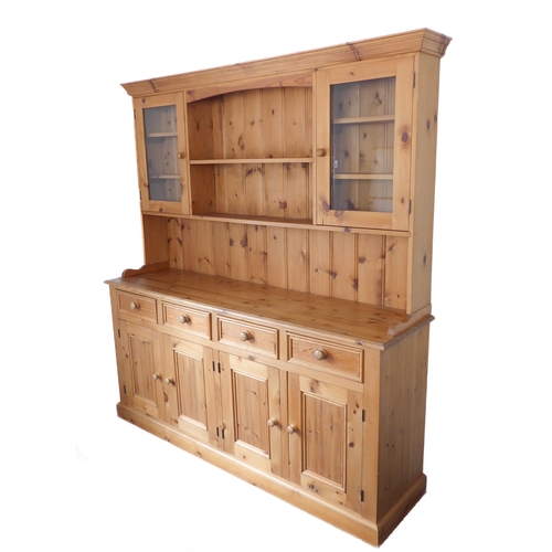 393 - A large 19th century style (good reproduction) pine dresser: the outset cornice above central shelf ... 