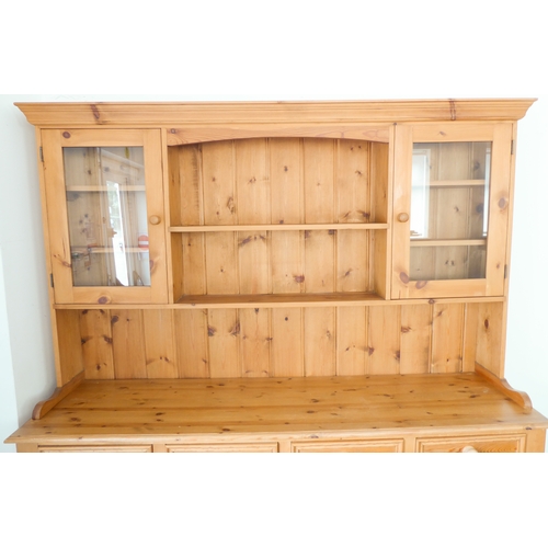 393 - A large 19th century style (good reproduction) pine dresser: the outset cornice above central shelf ... 