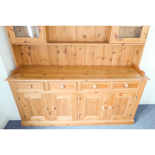 393 - A large 19th century style (good reproduction) pine dresser: the outset cornice above central shelf ... 