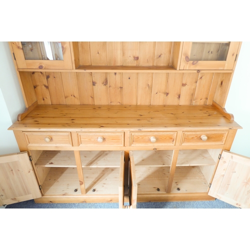 393 - A large 19th century style (good reproduction) pine dresser: the outset cornice above central shelf ... 