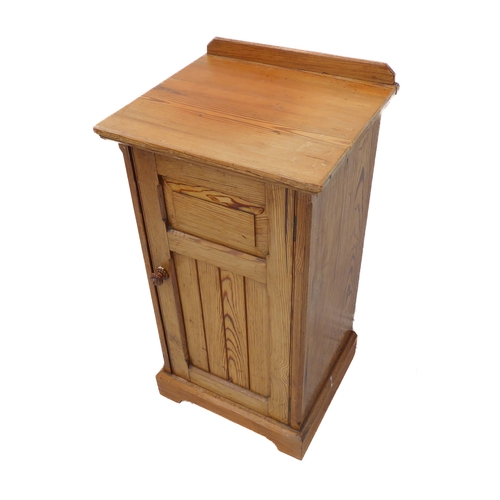 402 - A late 19th/early 20th century Oregon pine bedside cupboard: galleried top above single door with fi... 