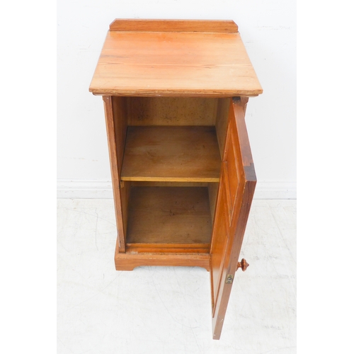 402 - A late 19th/early 20th century Oregon pine bedside cupboard: galleried top above single door with fi... 