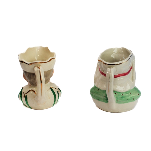 41 - A pair of 19th century Staffordshire Punch and Judy jugs (11 cm high)