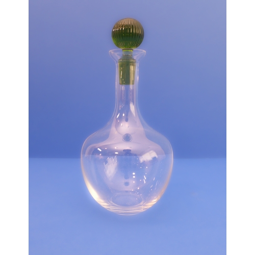 67 - A set of six Murano decanters; clear-glass onion bodies and green-glass stoppers (28cm high)