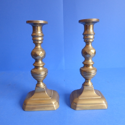 81 - Three pairs of 19th century brass candlesticks (two pairs with ejector sticks) (the tallest 24.5cm)