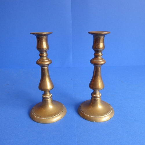 81 - Three pairs of 19th century brass candlesticks (two pairs with ejector sticks) (the tallest 24.5cm)