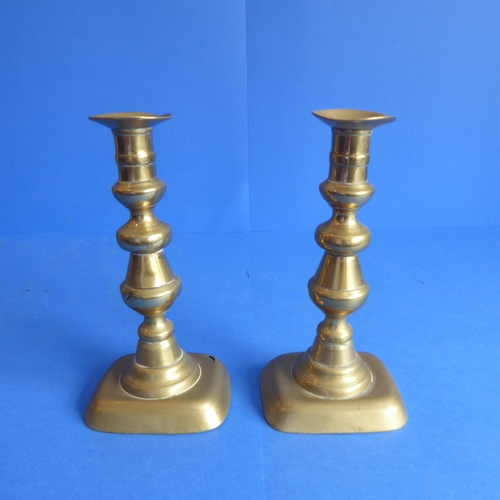 81 - Three pairs of 19th century brass candlesticks (two pairs with ejector sticks) (the tallest 24.5cm)