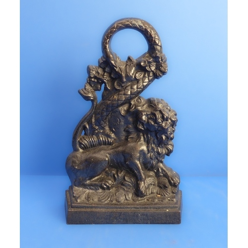 82 - A heavy cast iron doorstop modelled as a lion and serpent (probably 19th century), together with a 1... 