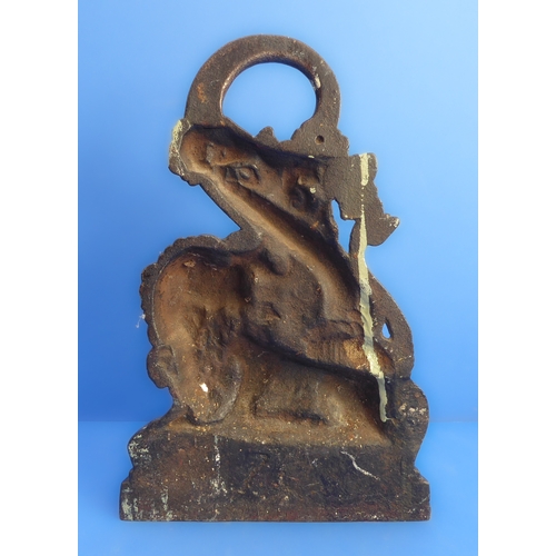 82 - A heavy cast iron doorstop modelled as a lion and serpent (probably 19th century), together with a 1... 