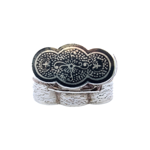 87 - An unusual silver pill box with niello decorated lid and engraved body