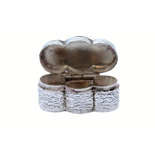 87 - An unusual silver pill box with niello decorated lid and engraved body