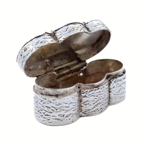 87 - An unusual silver pill box with niello decorated lid and engraved body