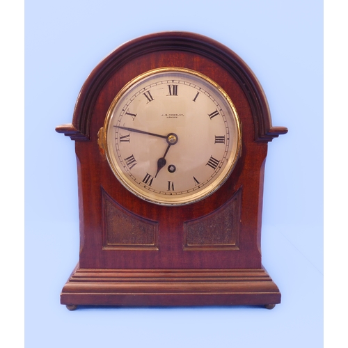 164 - An early 20th century mahogany-cased mantle clock: the silver-coloured dial with Roman numerals and ... 