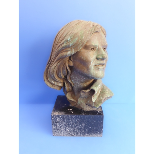 203 - A 20th century bronzed shoulder-length female portrait bust upon a heavy marble/black granite plinth... 