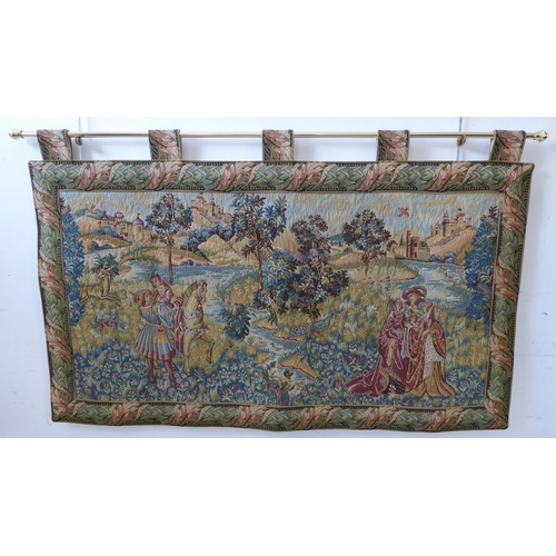 269 - A wall-hanging cotton tapestry depicting a medieval style scene with buildings, castles, a lake, fig... 