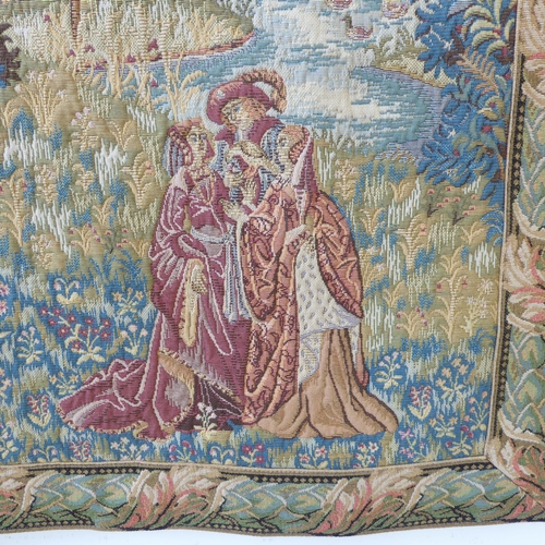 269 - A wall-hanging cotton tapestry depicting a medieval style scene with buildings, castles, a lake, fig... 