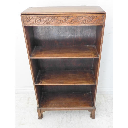 294 - An early 20th century oak bookshelf of slim proportions foliate carved frieze ad on shaped legs (52c... 