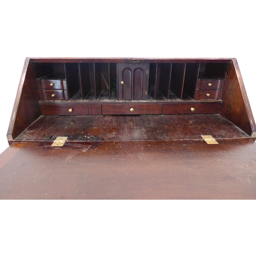 316 - An 18th century mahogany writing bureau: the angular cleated fall opening to reveal fully-fitted int... 