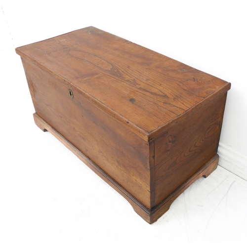 321 - An early to mid 19th century elm chest: the lid with strap hinges above short bracket feet (83cm wid... 