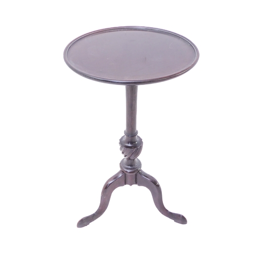 322 - An early 20th century mahogany wine table in Georgian style: the dished-top above turned stem and tr... 