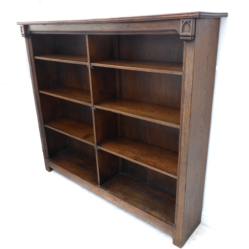 323 - A good early 20th century solid oak bookcase: the slightly overhanging reeded top above half-shelves... 