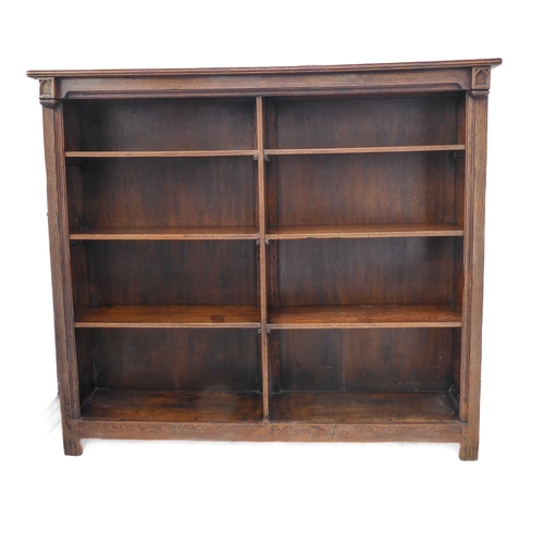 323 - A good early 20th century solid oak bookcase: the slightly overhanging reeded top above half-shelves... 