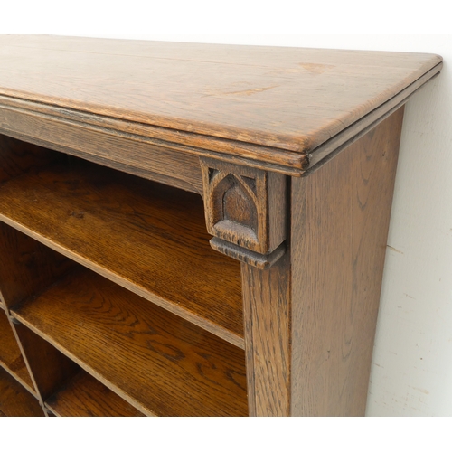 323 - A good early 20th century solid oak bookcase: the slightly overhanging reeded top above half-shelves... 