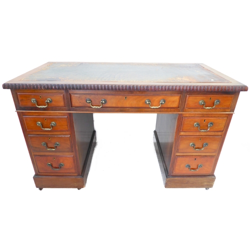 327 - An early 20th century walnut pedestal desk: the leather inset top with gadrooned moulding an arrange... 