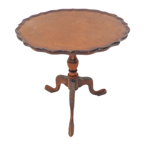 363 - A walnut occasional table: the figured walnut scallop edge top above turned stem and tripod base wit... 