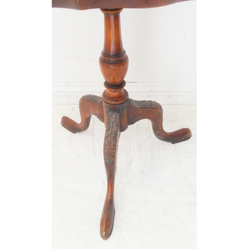 363 - A walnut occasional table: the figured walnut scallop edge top above turned stem and tripod base wit... 