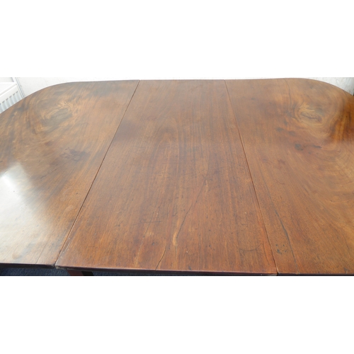 389 - A large 19th century extending mahogany D-end dining table with two extra leaves: raised on square t... 