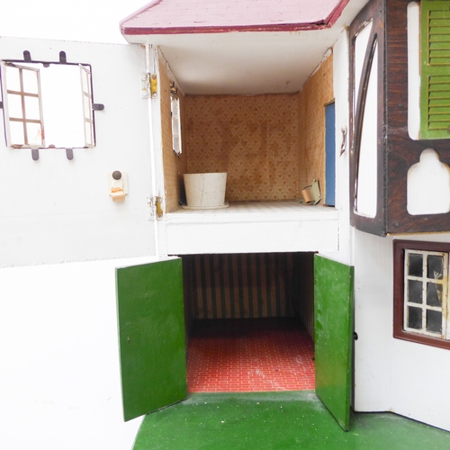 404 - A large bespoke painted doll's house on stand (possibly 1930s/40s): twin-gabled with a multitude of ... 