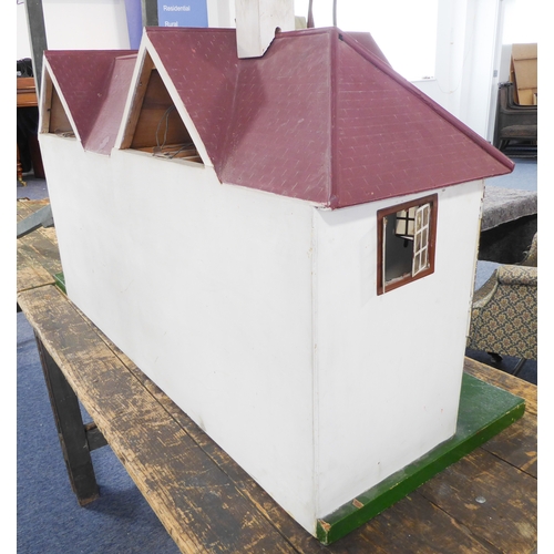 404 - A large bespoke painted doll's house on stand (possibly 1930s/40s): twin-gabled with a multitude of ... 