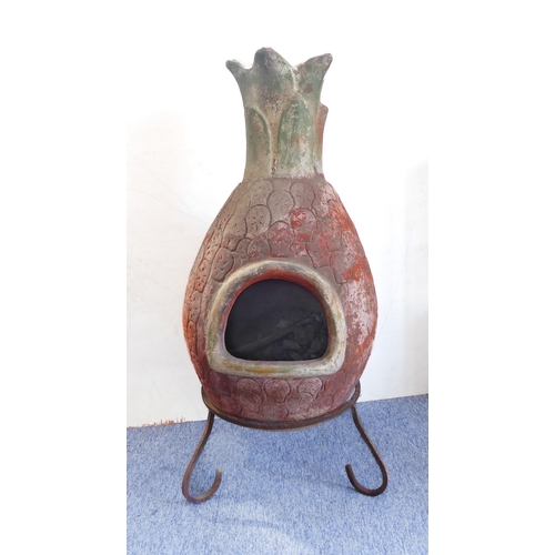 443 - A terracotta chimenea on shaped iron stand: approx. 112cm high including stand