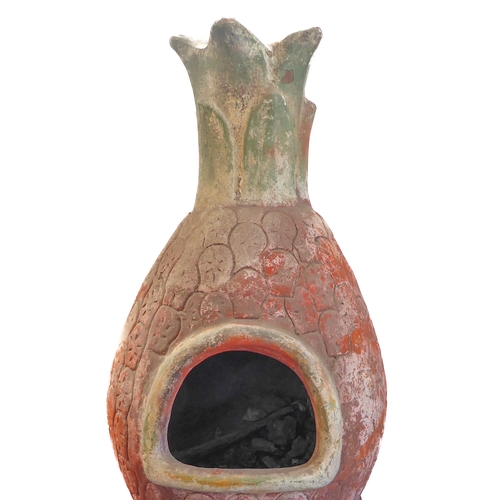 443 - A terracotta chimenea on shaped iron stand: approx. 112cm high including stand