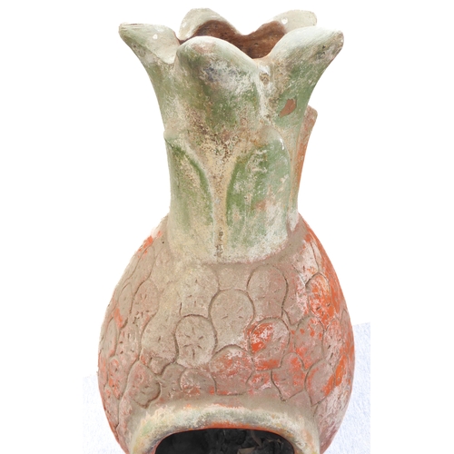 443 - A terracotta chimenea on shaped iron stand: approx. 112cm high including stand