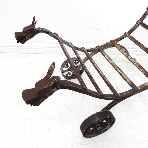 445 - An unusual blacksmith-made wrought-iron garden stand of cradle form. Two looping handles above horiz... 