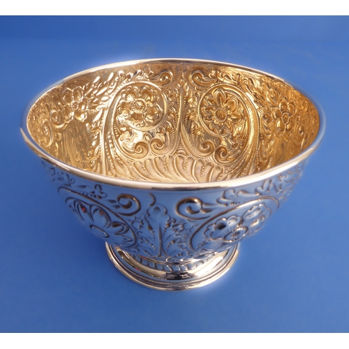 86 - A hallmarked silver sugar bowl: gilded interior and decorated in repoussé style with flowerheads, C-... 