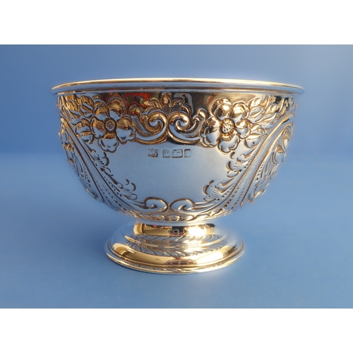 86 - A hallmarked silver sugar bowl: gilded interior and decorated in repoussé style with flowerheads, C-... 