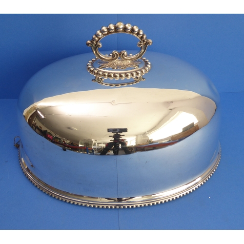 99 - A large late 19th century dome-shaped silver-plated meat cover with gadrooned edge (dent to one end)... 