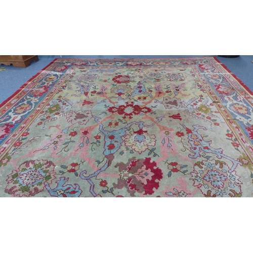 250 - A large hand-knotted Ushak style carpet (possibly Donegal, Arts & Crafts); the light lime-green pred... 