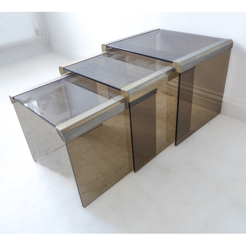 311 - A nest of three modern Designer smoked-glass and gilt-metal mounted (rubbed) occasional tables (the ... 