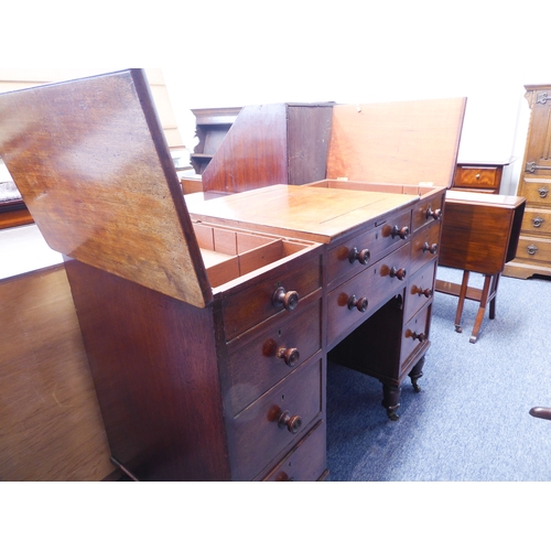 339 - An unusual early 19th century mahogany desk; the central square section with cleating sliding forwar... 