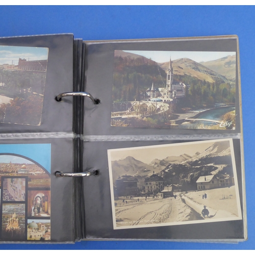 193 - A vellum-bound postcard album containing a selection of colour and monochrome postcards to include V... 